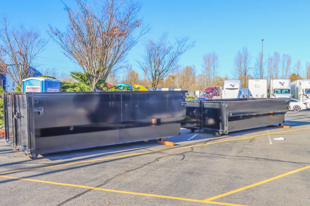 Professional dumpster rental service with roll-off container on residential driveway in Aliquippa